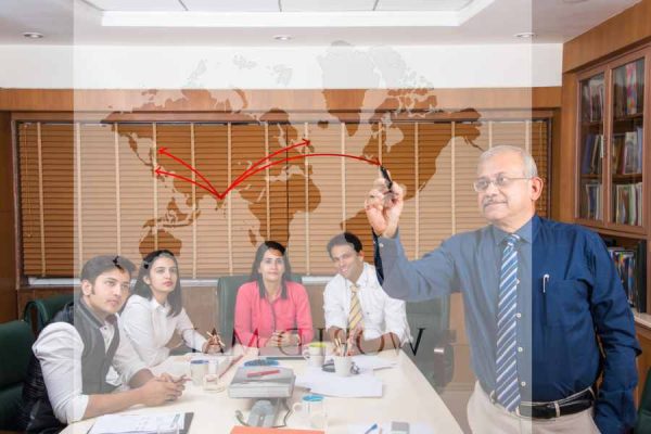 indian-senior-businessman-writing-transparent-glass-with-presentation-meeting.jpg