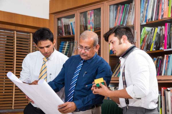 team-indian-architects-builders-drafting-discussing-housing-project.jpg