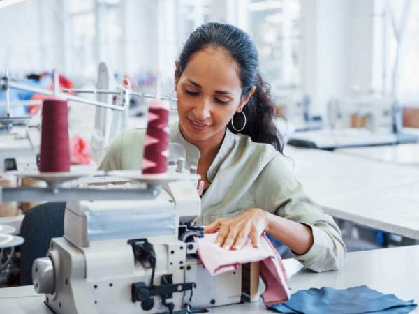 woman-sews-clothes-sewing-machine-factory.jpg